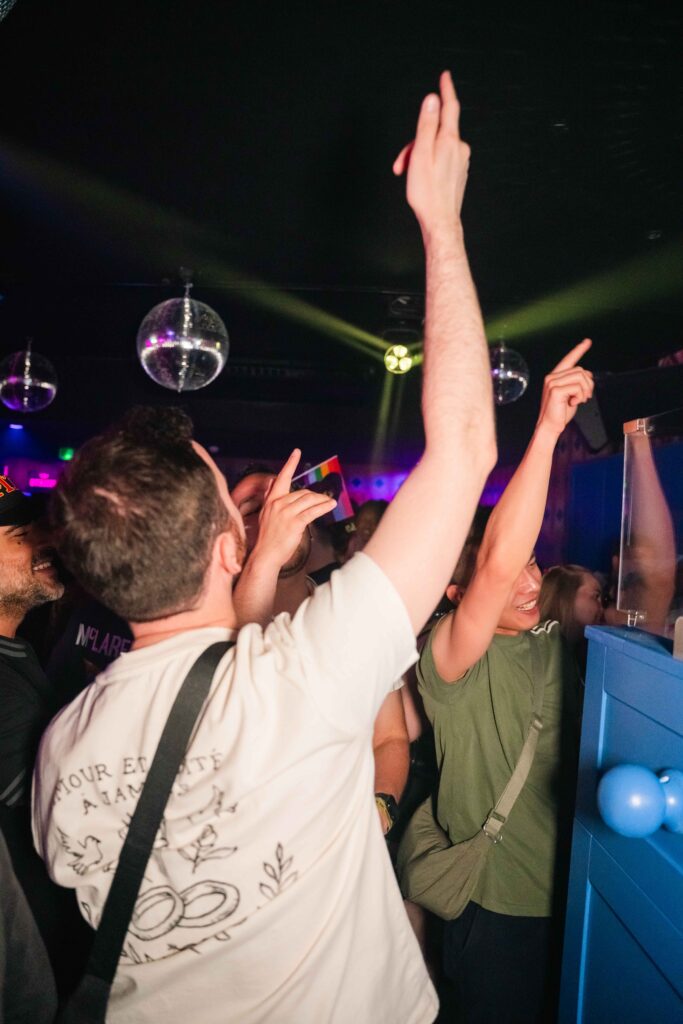 Crowd dancing under disco balls at Campus Liverpool