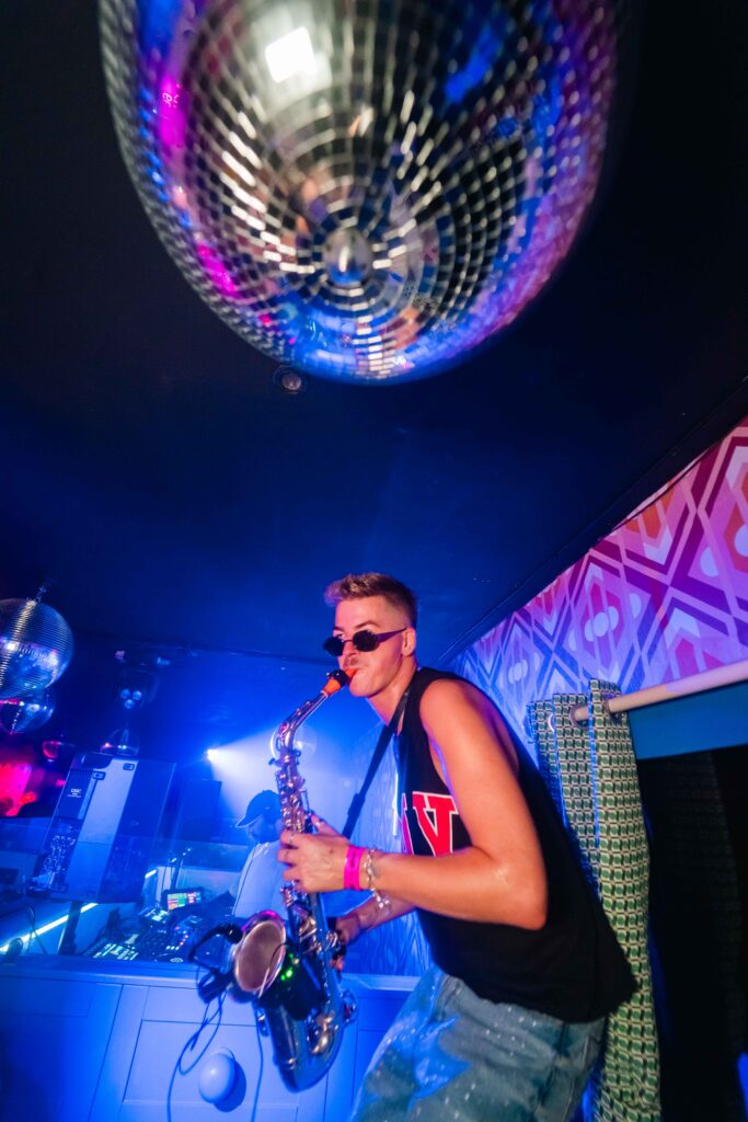 DJ performing beneath a disco ball at Campus Liverpool